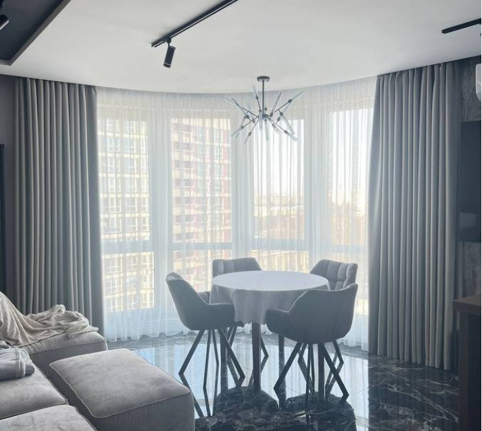 Curtains on a bay window in a studio apartment 20202128